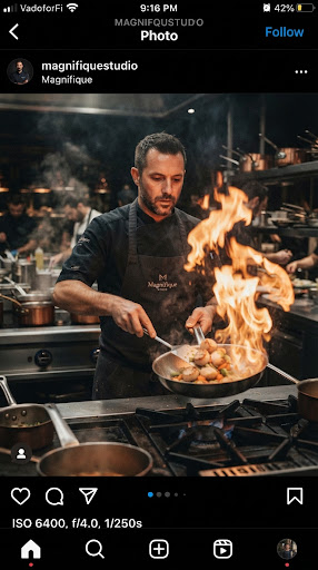 Vertical reel still of a chef flaming a dish in a moody high-end kitchen.