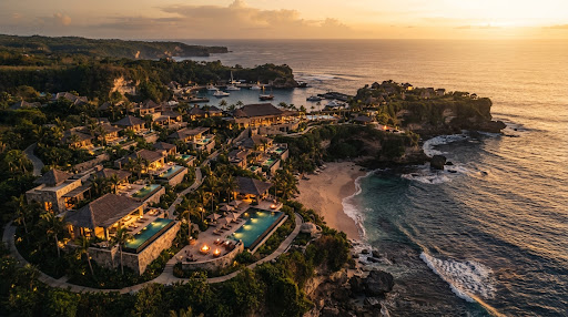Breathtaking 4K drone shot of a luxury coastal resort at golden hour, warm cinematic lighting, deep shadows, high-end travel aesthetic, sharp details.
